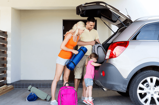 Family unloading from rear of an SUV