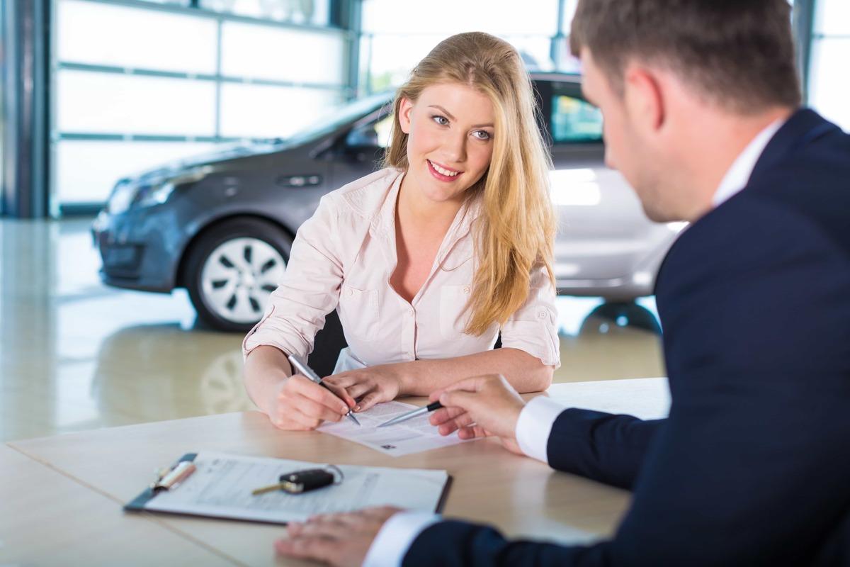 Applying for car lease in showroom